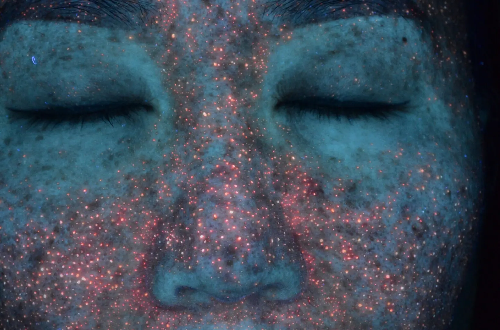 A face with blue and pink dust all over it.