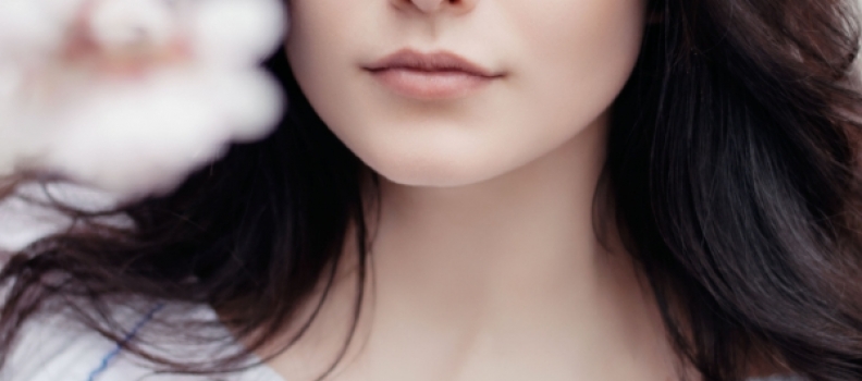 A close up of a woman 's face with her nose and lips.