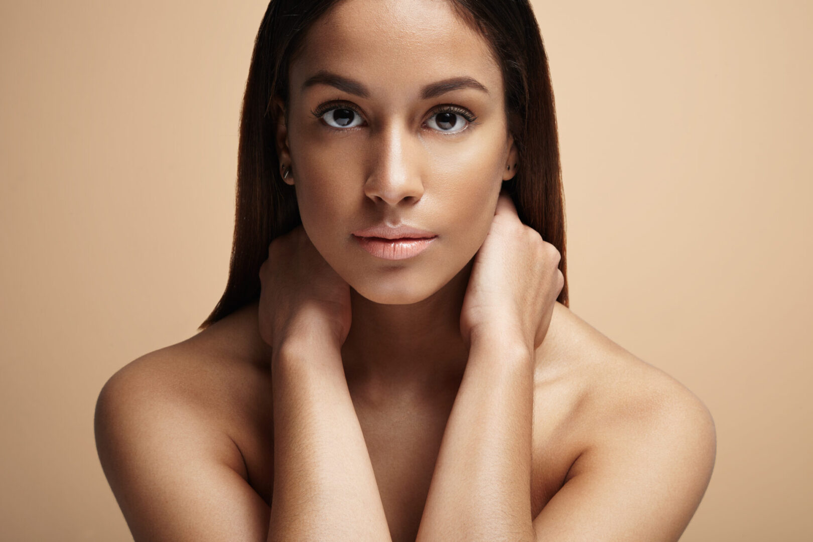 A woman with her hands on the neck of another person.