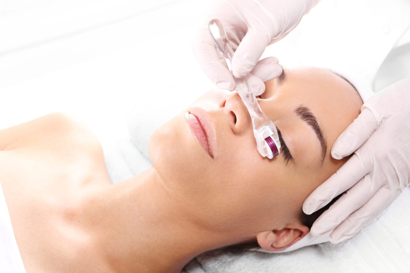 A woman getting her face waxed at the spa