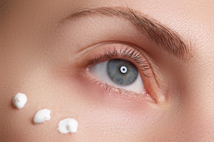 A close up of a person 's eye with cream on it