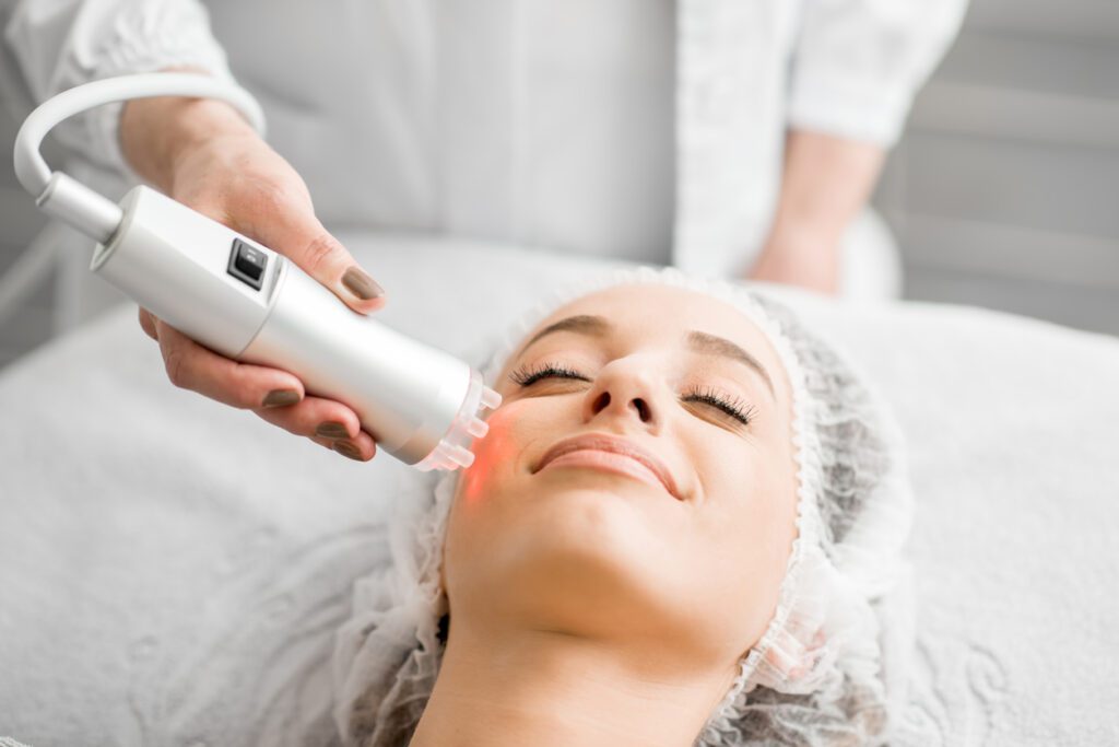 A woman getting her face waxed at the spa