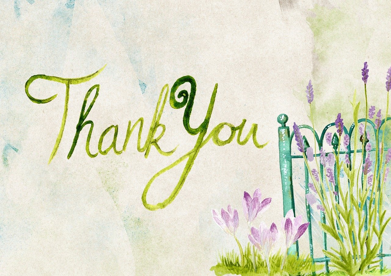 A thank you card with purple flowers and green grass.