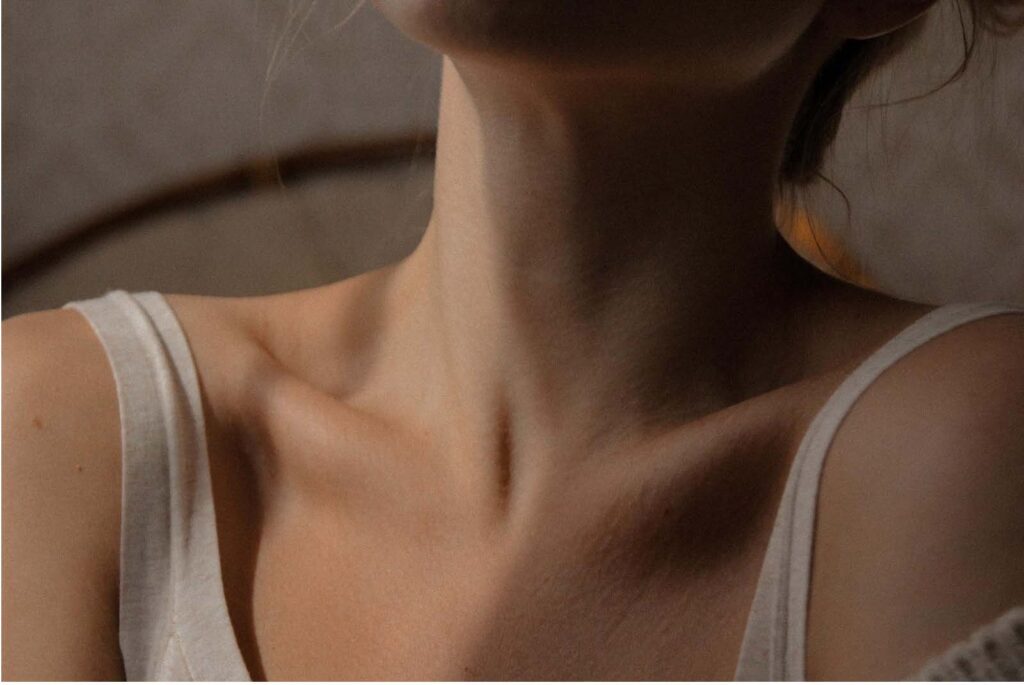 A woman with her neck and chest exposed.